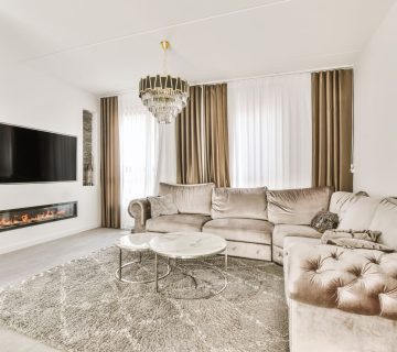 49295290 a living room with a couch and a tv 360x320 - Combining Tile Flooring with a Cozy Fireplace